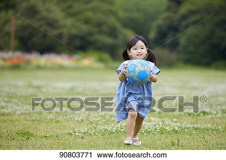 Stock Image - Japanese kid at a city park. Fotosearch