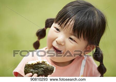 Stock Image - Japanese kid at a city park. Fotosearch