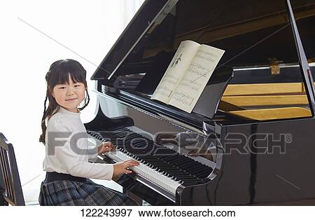 Japanese kid practicing piano View Large Photo Image Stock Photo - Japanese kid practicing piano. Fotosearch
