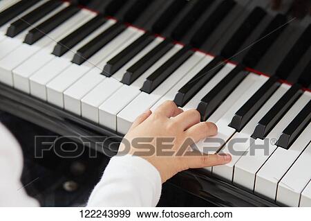 Stock Photo - Japanese kid practicing piano. Fotosearch