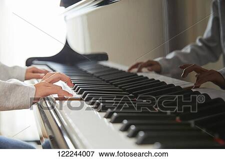 Stock Photo - Japanese kid practicing piano. Fotosearch