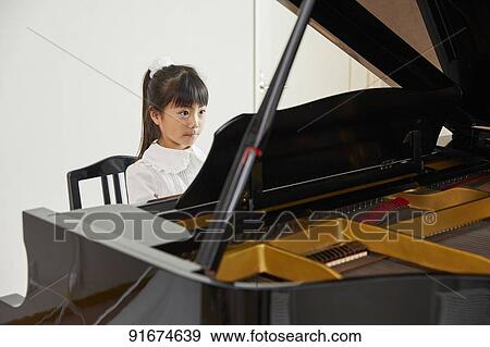 Japanese kid practicing piano View Large Photo Image Stock Photo - Japanese kid practicing piano. Fotosearch