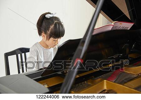 Japanese kid practicing piano View Large Photo Image Stock Photograph - Japanese kid practicing piano. Fotosearch