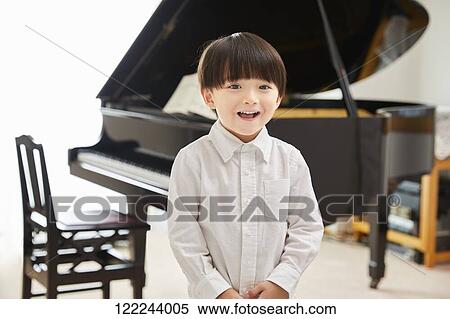 Japanese kid practicing piano View Large Photo Image Stock Photography - Japanese kid practicing piano. Fotosearch