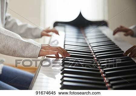 Japanese kid practicing piano View Large Photo Image Stock Photography - Japanese kid practicing piano. Fotosearch