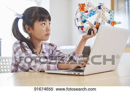 Stock Photography - Japanese kid practicing programming. Fotosearch