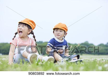Stock Image - Japanese kids at a city park. Fotosearch