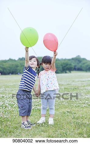Stock Image - Japanese kids at a city park. Fotosearch
