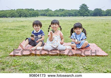 Stock Image - Japanese kids at a city park. Fotosearch
