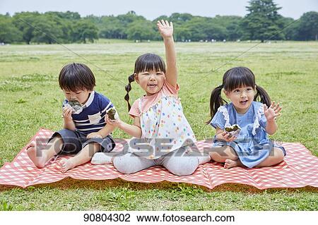 Stock Image - Japanese kids at a city park. Fotosearch