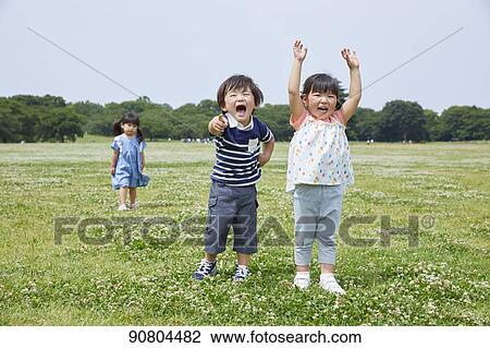 Stock Image - Japanese kids at a city park. Fotosearch