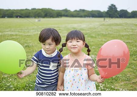 Stock Image - Japanese kids at a city park. Fotosearch