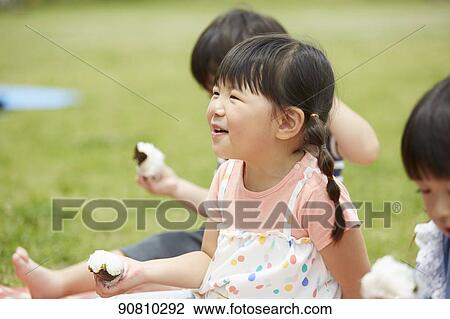 Stock Image - Japanese kids at a city park. Fotosearch