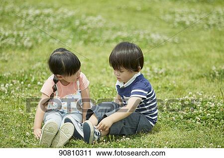 Stock Image - Japanese kids at a city park. Fotosearch