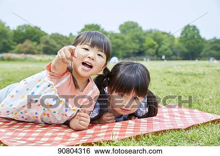 Stock Photograph - Japanese kids at a city park. Fotosearch