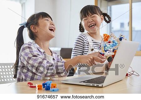 Stock Photo - Japanese kids practicing programming. Fotosearch
