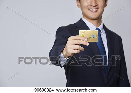 Japanese man holding credit card View Large Photo Image Picture - Japanese man holding credit card. Fotosearch