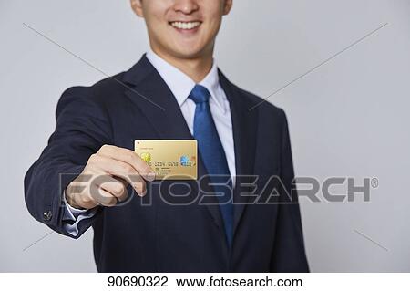 Japanese man holding credit card View Large Photo Image Stock Image - Japanese man holding credit card. Fotosearch