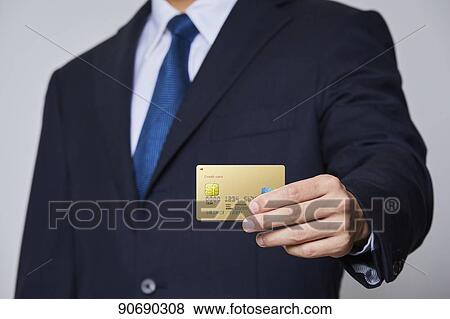 Japanese man holding credit card View Large Photo Image Stock Photo - Japanese man holding credit card. Fotosearch