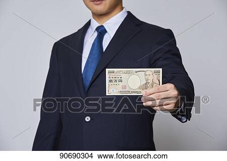 Japanese man holding money bills View Large Photo Image Picture - Japanese man holding money bills. Fotosearch