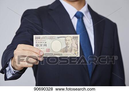 Japanese man holding money bills View Large Photo Image Stock Photo - Japanese man holding money bills. Fotosearch
