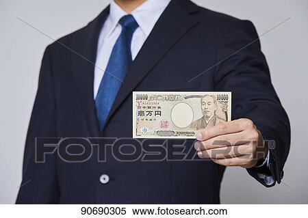 Stock Photography - Japanese man holding money bills. Fotosearch