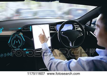 Stock Photo - Japanese man in self driving car. Fotosearch