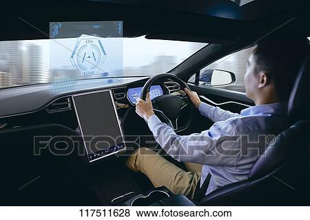 Stock Photo - Japanese man in self driving car. Fotosearch