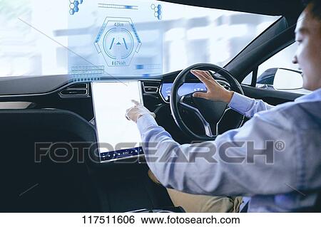 Stock Photograph - Japanese man in self driving car. Fotosearch