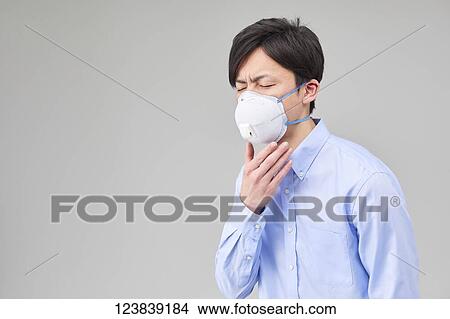 Picture - Japanese man wearing mask. Fotosearch