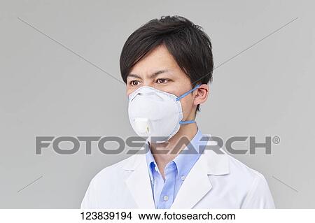 Picture - Japanese man wearing mask. Fotosearch