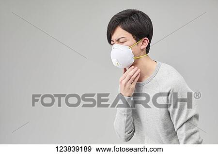 Stock Photo - Japanese man wearing mask. Fotosearch