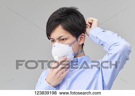 Stock Photo - Japanese man wearing mask. Fotosearch