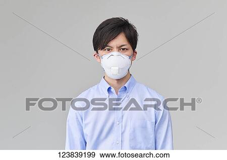 Stock Photo - Japanese man wearing mask. Fotosearch