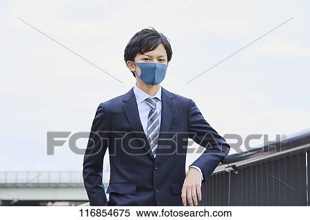 Stock Photography - Japanese man wearing mask. Fotosearch