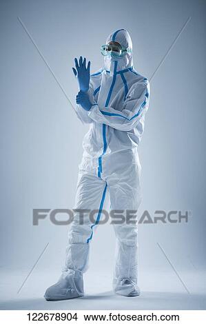 Picture - Japanese man wearing protective suit for disease prevention. Fotosearch