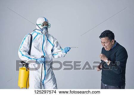 Japanese man wearing protective suit for disease prevention View Large Photo Image Picture - Japanese man wearing protective suit for disease prevention. Fotosearch