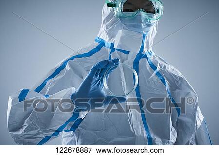 Stock Photo - Japanese man wearing protective suit for disease prevention. Fotosearch