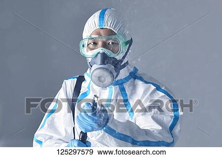 Japanese man wearing protective suit for disease prevention View Large Photo Image Stock Photo - Japanese man wearing protective suit for disease prevention. Fotosearch