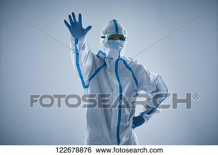Stock Photograph - Japanese man wearing protective suit for disease prevention. Fotosearch