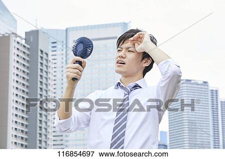 Japanese man with portable fan View Large Photo Image Stock Photo - Japanese man with portable fan. Fotosearch