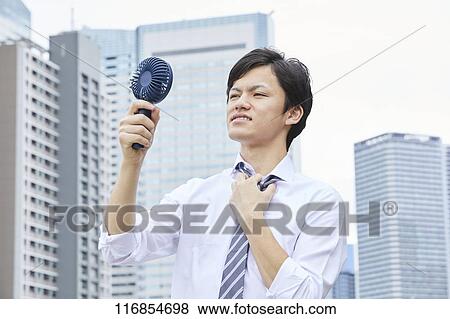 Japanese man with portable fan View Large Photo Image Stock Photo - Japanese man with portable fan. Fotosearch