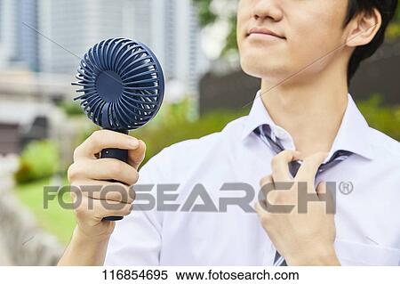 Japanese man with portable fan View Large Photo Image Stock Photography - Japanese man with portable fan. Fotosearch