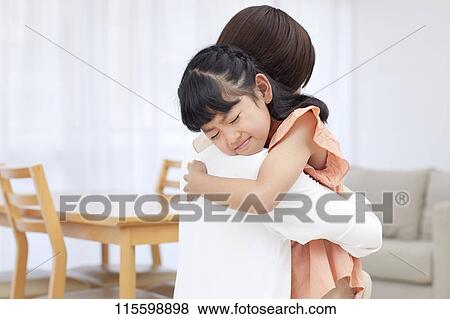 Japanese mother hugging daughter View Large Photo Image Stock Photo - Japanese mother hugging daughter. Fotosearch
