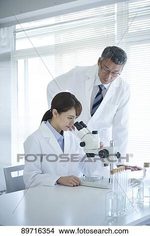 Picture - Japanese researchers in the lab. Fotosearch