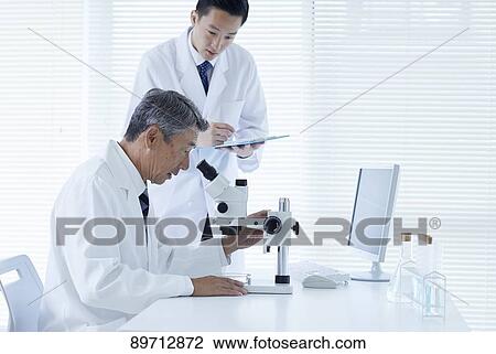 Stock Image - Japanese researchers in the lab. Fotosearch