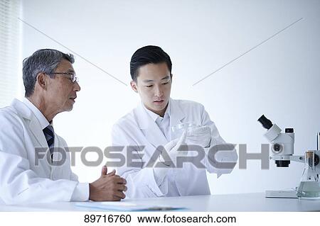 Stock Image - Japanese researchers in the lab. Fotosearch