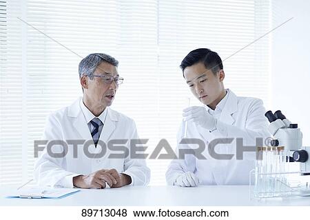 Stock Photo - Japanese researchers in the lab. Fotosearch