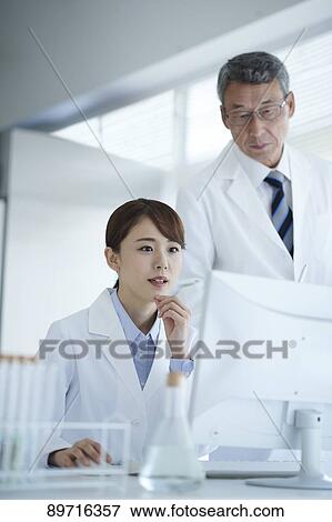 Stock Photo - Japanese researchers in the lab. Fotosearch