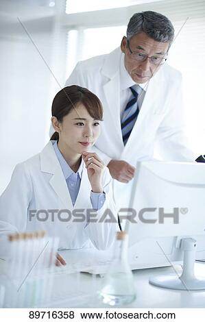 Stock Photo - Japanese researchers in the lab. Fotosearch
